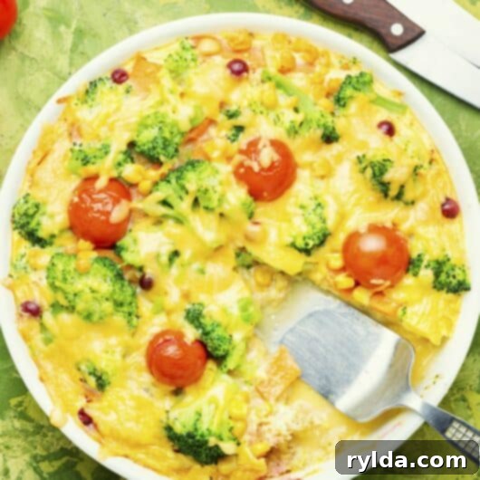 Overnight Breakfast Pie with ham, broccoli, and Swiss cheese, golden brown and bubbly