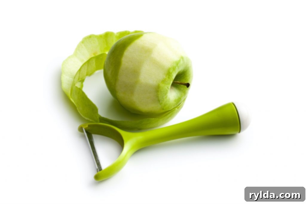 Peeled Granny Smith apple, ready for apple pie