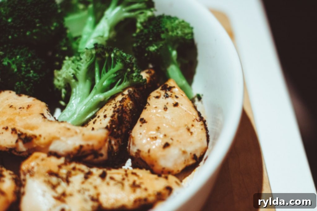 Perfectly cooked golden brown chicken cubes and tender green broccoli florets, cooked and set aside, waiting to be gently folded into the creamy penne pasta sauce.