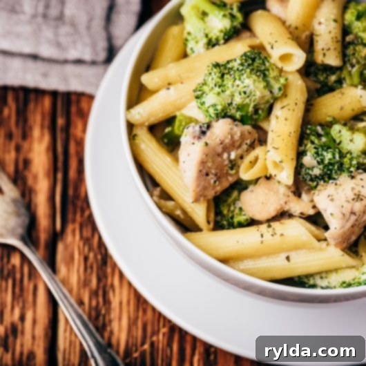A vibrant and comforting bowl of Creamy Broccoli Chicken Penne pasta dish, garnished with fresh parsley and an extra sprinkle of Parmesan, ready to be enjoyed.