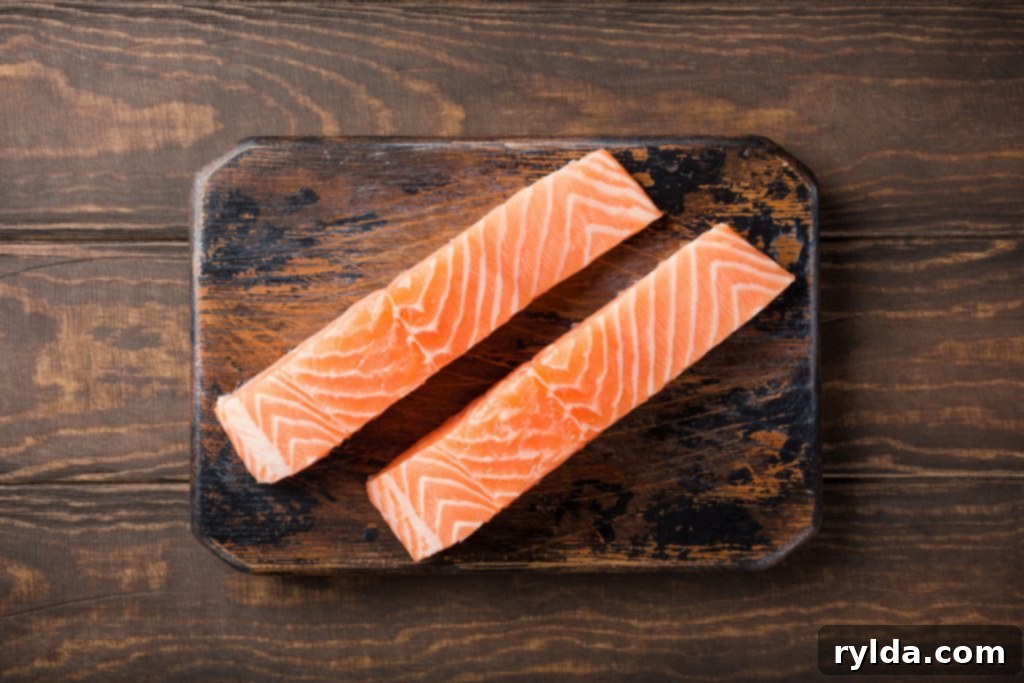 Golden Herb Garlic Baked Salmon 2 Fresh raw salmon fillets, flat lay.