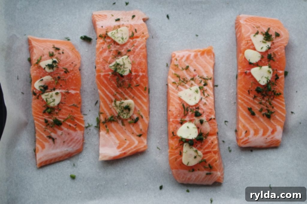Golden Herb Garlic Baked Salmon 5 Salmon fillets seasoned and ready for baking.