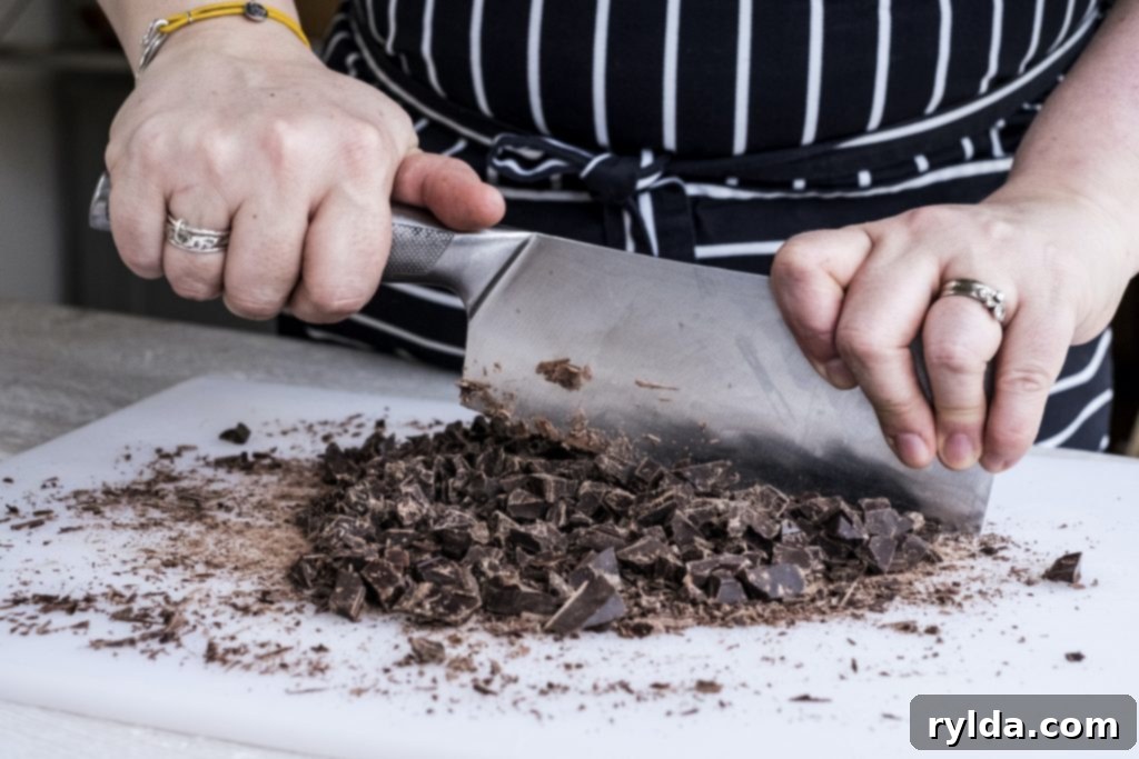 Decadent Triple-Layer Millionaire Bars 2 Chopping semi-sweet baking chocolate into smaller pieces for easier melting for Millionaire Shortbread Bars