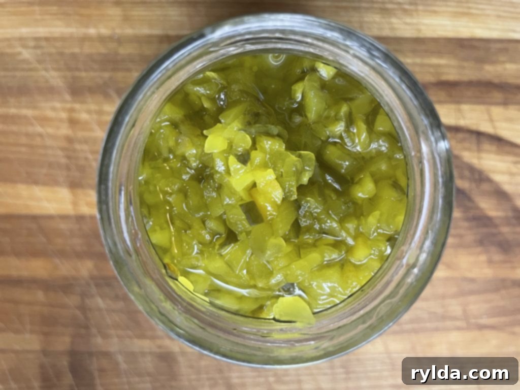 Dill pickle relish jar next to a bowl of macaroni salad