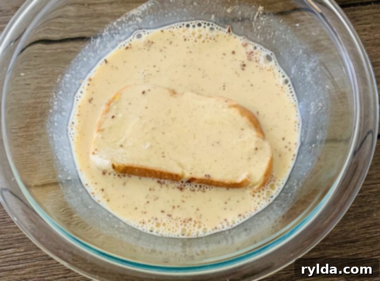 Challah bread soaking in egg mixture for French toast