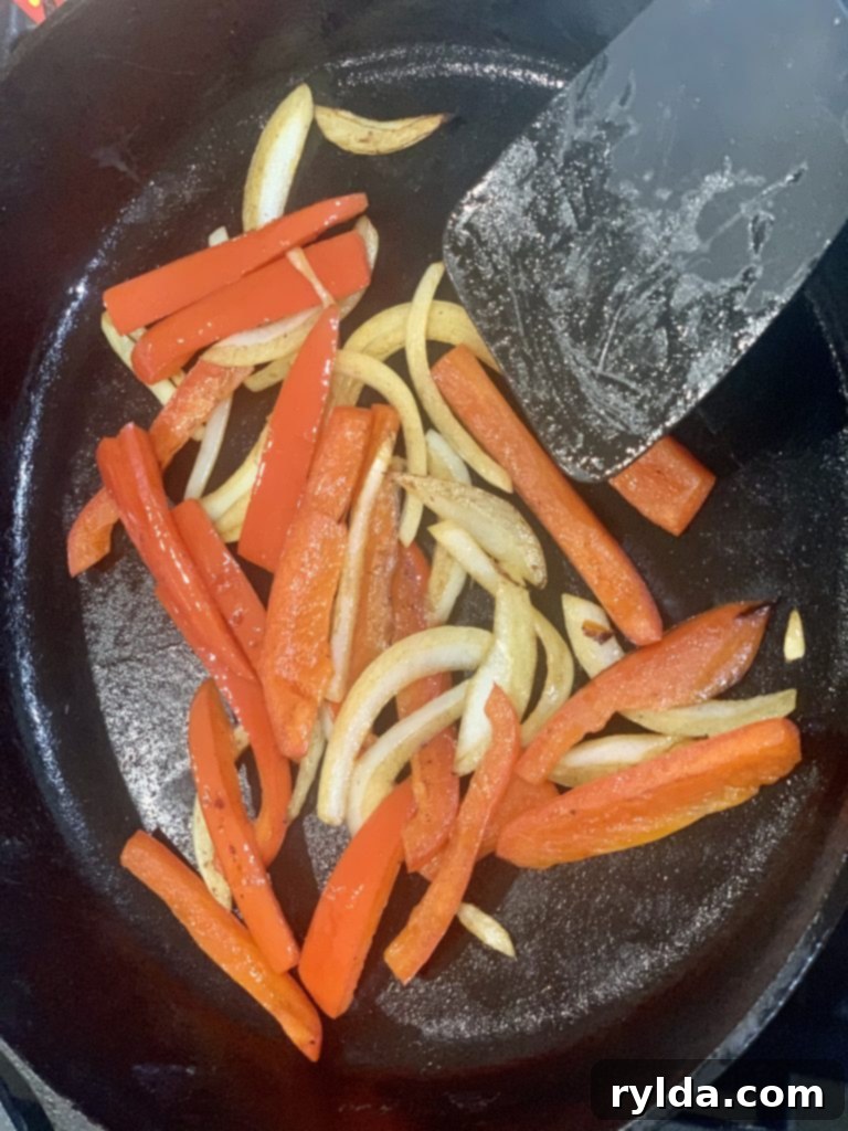 Close-up of cooked red bell pepper and onion slices