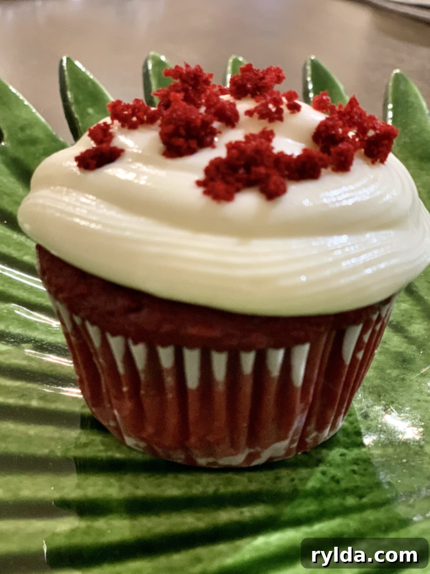 Decorated Red Velvet Cupcakes with swirls of cream cheese frosting and red velvet crumbs, ready to be enjoyed.