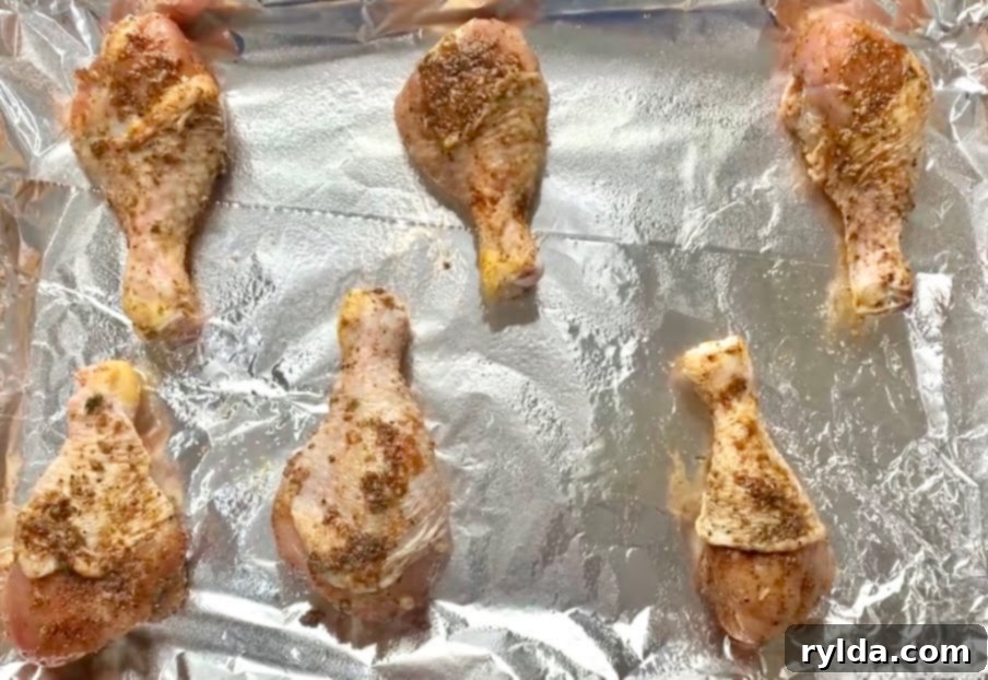 Oven baked chicken drumsticks arranged on a plate with fresh parsley