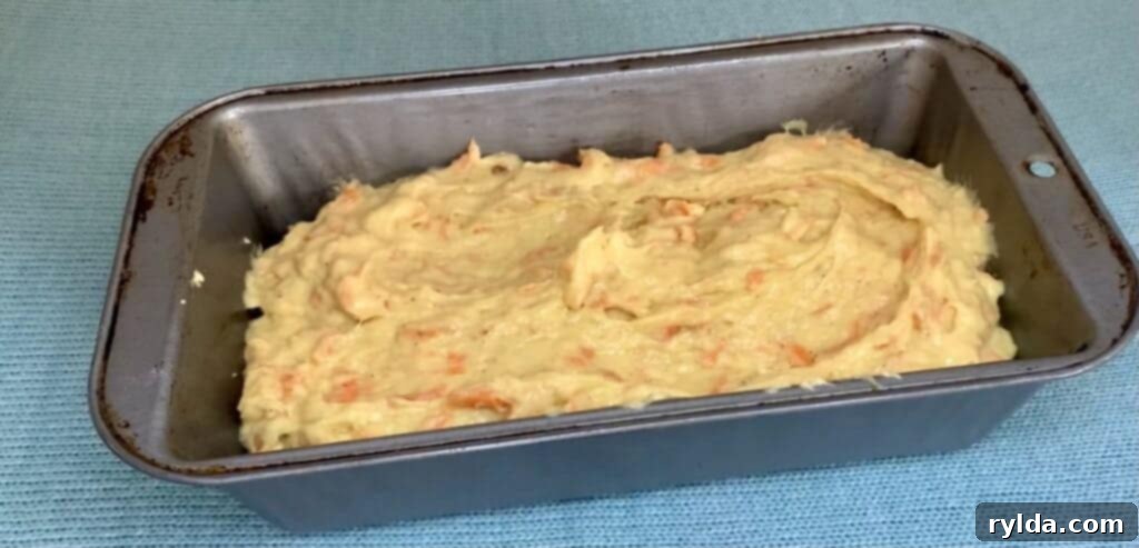 Banana Carrot Loaf batter spread evenly in a loaf pan, ready for the oven to bake to golden perfection.