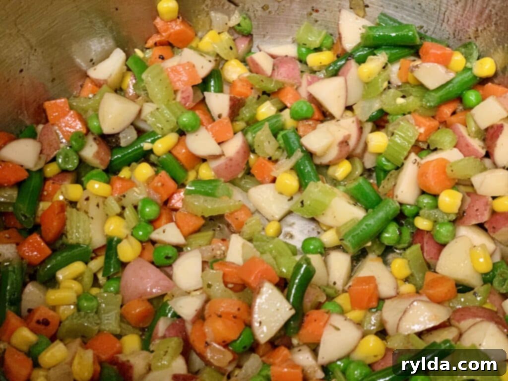 Hearty vegetable soup simmering in a pot