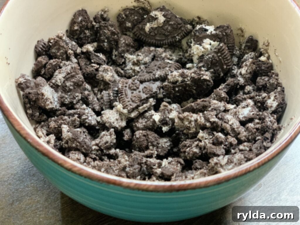 Close-up of freshly crushed Oreo cookies, ready to be folded into the creamy dip mixture.