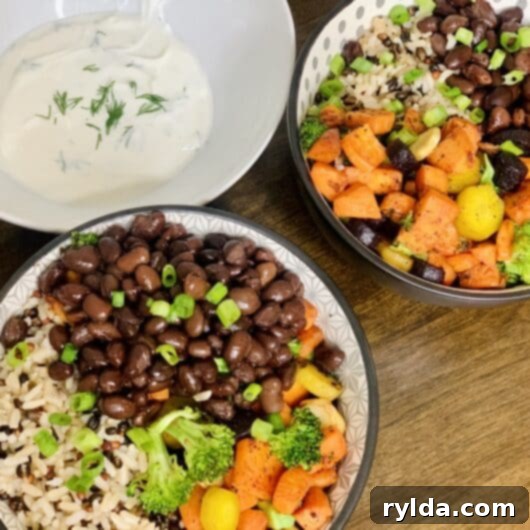 A vibrant grain bowl with rice, roasted vegetables, and a creamy dressing.