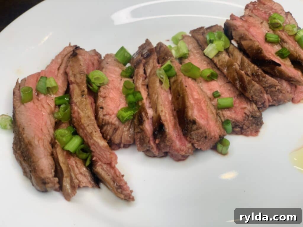 Plated marinated pan-seared flank steak with sides