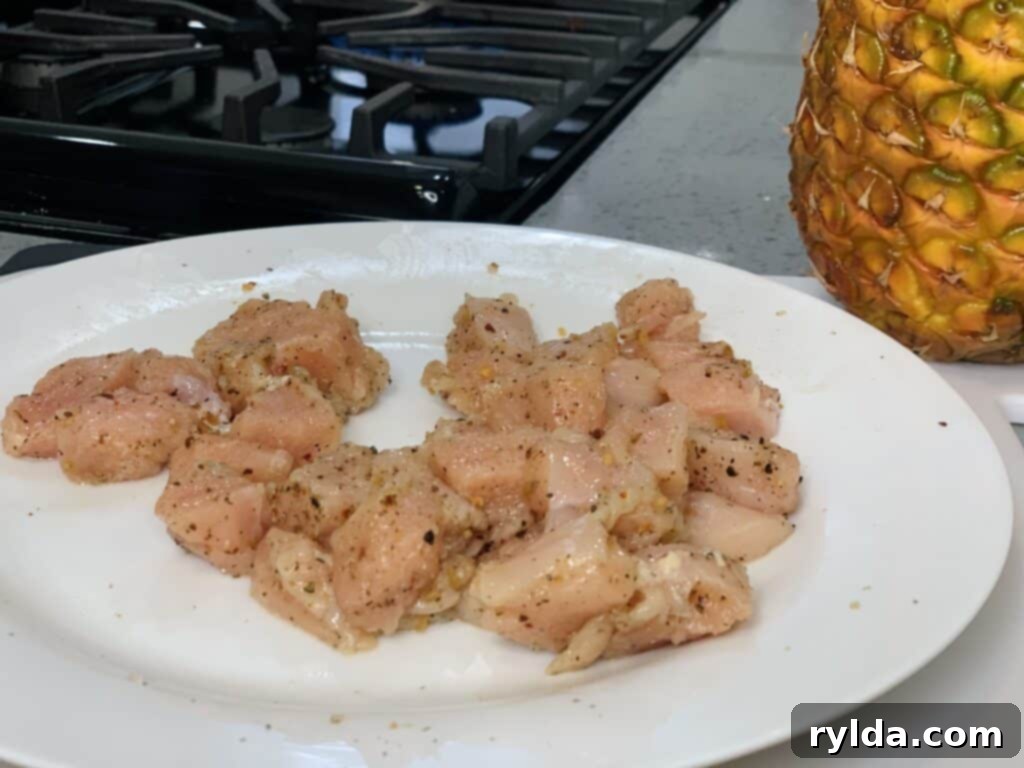 Pan-fried chicken pieces with pineapple chunks and broccoli florets, perfectly cooked and ready for the sauce.