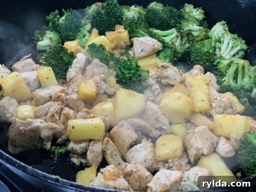 A close-up of vibrant, freshly cut pineapple chunks, perfect for cooking or blending into sauce.