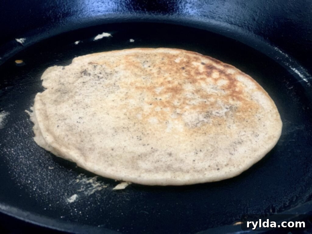 Bubbles forming on a buttermilk pancake, indicating it's ready to flip