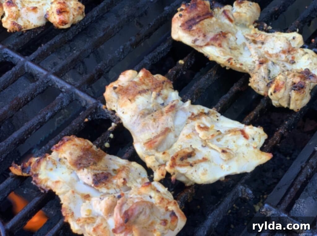 Chicken thighs grilling on a hot gril