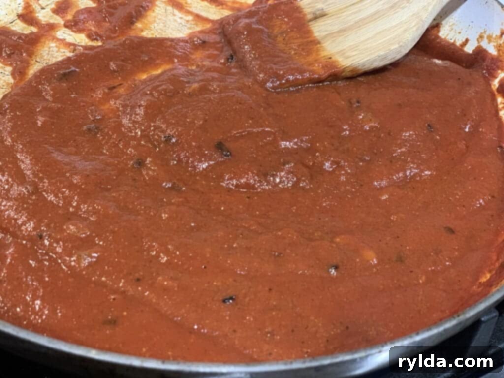 Chana Masala simmering in a skillet, showcasing the rich, vibrant color of the curry.