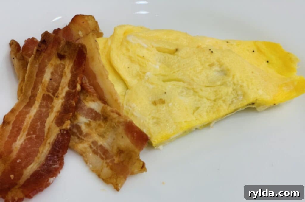 A freshly made Bacon, Egg, and Cheese Croissant, ready to be enjoyed with a hot cup of coffee.
