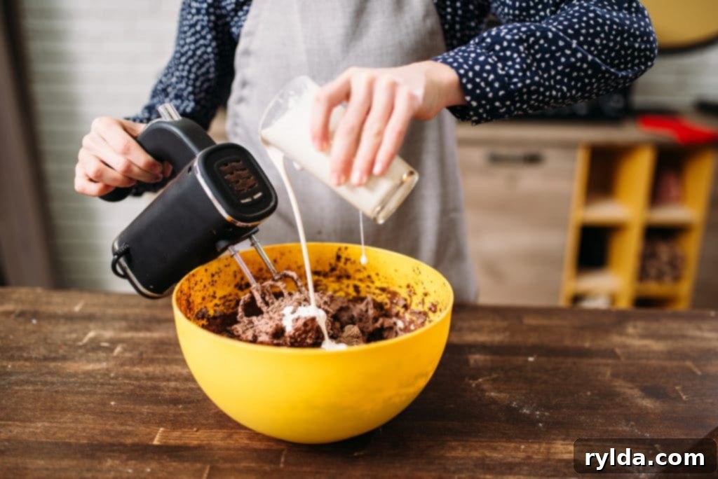 One Bowl Wonder Chocolate Cake 2 Mixing cake batter in a stand mixer, demonstrating the one-bowl convenience for a homemade chocolate cake.